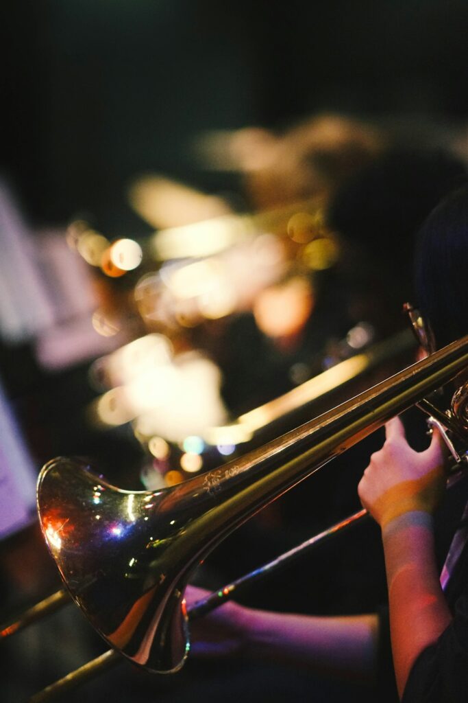 musician-playing-a-trombone-with-warm-bokeh-lights-gwc-iulghra Trombone player in a jazz band.